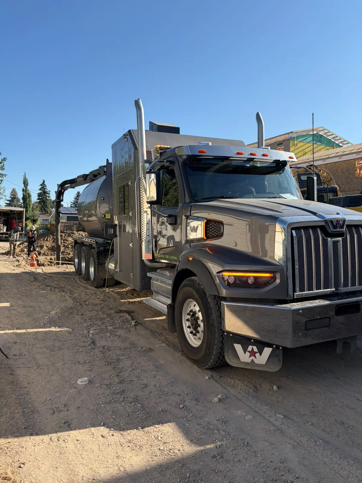 PTL Group Heavy-Duty Tri-Axle Hydrovac Unit PTL Group Western Star tri-axle hydrovac truck performing non-destructive utility daylighting on a residential excavation site.